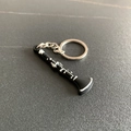 Cartoon clarinet keychain made of black PVC soft glue with a silver metal ring - Clarinet