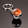Macro shot of Mars nebula glass ball keychain with silver metal base and keyring - Venus