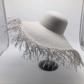 Detailed view of wide brim straw sun hat featuring trendy long frayed fringe edges - M (56-58cm) / Gray