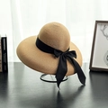 Detailed close-up of woven sun hat featuring a wide brim and elegant black ribbon bow - M (56-58cm) / Khaki