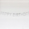 Silver glitter Happy Birthday banner for party decorations on white brick wall - Glitter Paper Solid Silver
