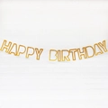 Golden Happy Birthday banner with metallic finish on white brick background wall - Glitter Paper Hollow Gold