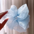 Light blue organza oversized scrunchie with soft pleated mesh texture held by hand - Oversized / Blue