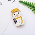 Macro detail of snowman brooch with yellow hat and blue gift box on white background - 30# Christmas Snowman