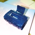 Detail of dark blue acetate hair claw clip with glitter finish and hollow square design - Starry Sky Blue Glitter Claw