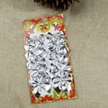 Set of 12 silver glitter Christmas bows with festive Santa packaging on burlap base - Silver