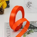 Bright orange satin ribbon roll for gift wrapping and festive wedding decorations - Orange Red