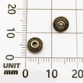 Detail view of 8mm bronze alloy spacer beads showing dot texture and size on scale paper - UFO Bead (10150)