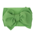 Detail of grass green waffle fabric baby headband with a large decorative bow - Pre-tied Bow / Grass Green