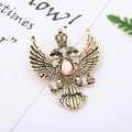 Macro detail of vintage double-headed eagle brooch with pink gemstone and antique gold finish - 18# Retro Double Eagle
