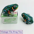 Classic green tin frog wind-up toy with vintage mechanical design and original packaging box - Clockwork Tin Frog