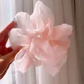 Pale pink organza scrunchie with fluffy pleated texture shown in natural light - Oversized / Pink