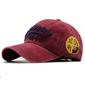 Detailed view of 3D embroidery and vintage washed cotton on a burgundy baseball cap - Adjustable / Burgundy