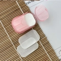 Portable pink soap paper case with white disposable flakes on a minimalist bamboo mat - Pink