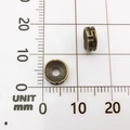 Two antique bronze alloy spacer beads with textured patterns shown on a scale ruler - Swastika Pattern Bead (10141)