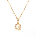 Detail of gold letter G pendant necklace with micro-pave sparkling crystal rhinestones - Letter G