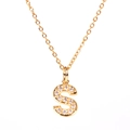 Macro shot of gold-plated S-letter pendant necklace with sparkling pavé zircons - Letter S