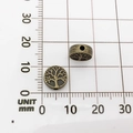 Detailed view of bronze metal tree beads on metric grid paper showing 12mm diameter size - Tree of Life (10138)