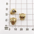 Three golden alloy lion head beads with black spots on a measurement scale background - Antique Gold Leopard Head