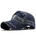 Close-up of vintage distressed baseball cap with Rebel embroidery and frayed edge details - Deep Blue/Grey