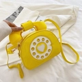 Creative yellow retro telephone crossbody bag in glossy finish with dial detail - Yellow