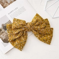 Detalle de pinza para el pelo con lazo grande amarillo mostaza y flores moradas - Flores Amarillas