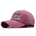Detail of pink cotton baseball cap featuring retro embroidery and white anchor stitching - Pink