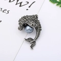 Detail of silver dolphin brooch featuring grey rhinestones and a large round imitation pearl - 15# Grey Dolphin