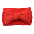 Red infant nylon headband featuring a large knotted textured fabric bow for girls - Red
