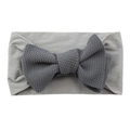 Close-up of soft grey baby headband with a dark grey knitted bow on white background - Dark Gray