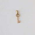 Detailed view of a polished 18k gold plated stainless steel heart-shaped key pendant - Z06 Tiny Heart Key