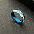 Macro shot of blue titanium steel ring with a single row of clear sparkling crystals - Blue
