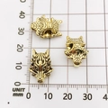 Three golden wolf head beads for DIY jewelry displayed on a millimeter measurement grid - Antique Gold Wolf Head