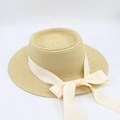 Detailed close-up of a beige flat-top straw hat with an elegant cream ribbon and bow - M (56-58cm) / Beige