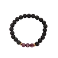 Detailed macro view of black lava stone beads with purple imperial stones and gold spacers - Lava Stone Coffee