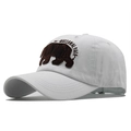Detail of bear embroidery and National Park lettering on white cotton baseball cap - White