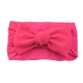 Pink nylon baby headband with a large knotted fabric bow on a clean white background - Rose Red