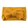 Mustard yellow nylon baby headband featuring a large textured fabric knot bow - Ginger Yellow
