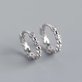 Macro shot of S925 sterling silver hoop earrings with bead accents and sparkling zircons - 925 Silver / White Gold