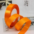 Roll of vibrant orange 2cm polyester satin ribbon for gift wrapping and wedding decor - Orange