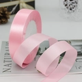 Pink satin ribbon in a spiral roll for gift wrapping and wedding decoration - Pink
