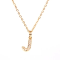 Detail of gold letter J pendant necklace with pavé cubic zirconia on cross chain - Letter J