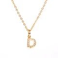 Detailed macro view of a gold-plated necklace with a diamond-encrusted letter D pendant - Letter D