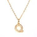 Detailed close-up of a gold-plated letter Q pendant necklace with sparkling cubic zirconia - Letter Q