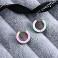 Macro shot of colorful rainbow titanium steel hoop earrings on soft grey velvet - Polished (Single Piece) / Colorful
