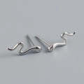 Macro view of S925 sterling silver snake stud earrings with crystal stone detail - 925 Silver / White Gold