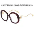 Fashionable dark tea oval sunglasses featuring wavy golden metal arms and pearl accents - Dark Tea Frame Clear Lens