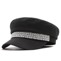 Chic black baker boy hat with decorative faux pearl and rhinestone band in a 45-degree view - One Size / Black