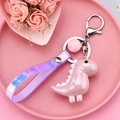 Süßer rosa Dinosaurier Schlüsselanhänger mit Hologramm-Band und Blumenhintergrund - Stil mit Handschlaufe und Perle / Rosa