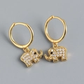 Detail of gold elephant earrings featuring sparkling white and black zircon stones - 925 Silver / Gold